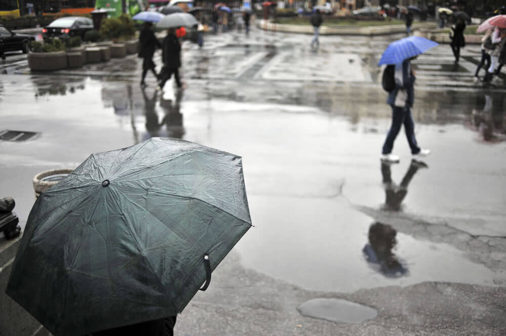 People walking with umbrellas on a rainy city street.