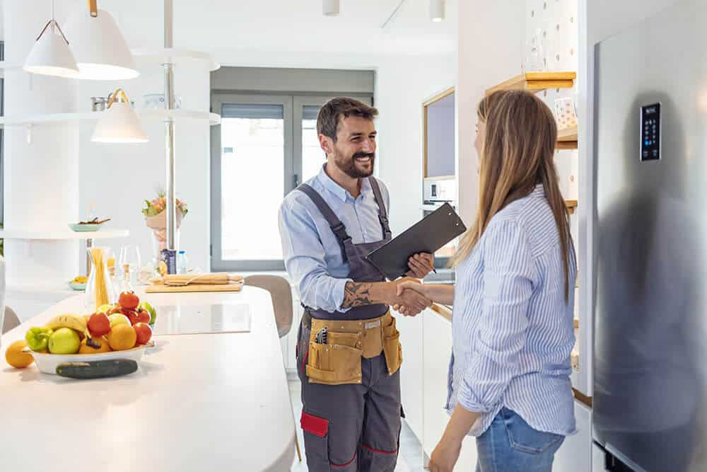woman shaking hands with contractor