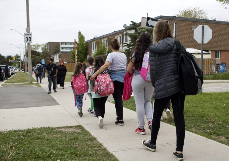 Children and parents walking home from school.
